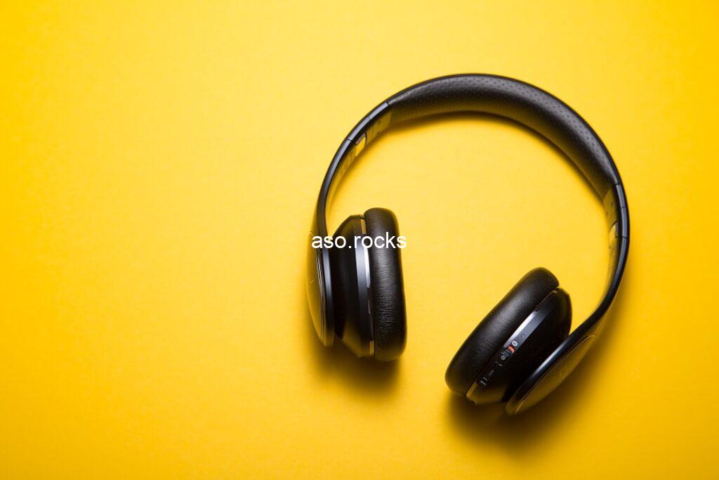 Black wireless headphones on yellow background representing music listening and streaming